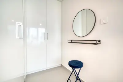 a bathroom with a mirror and a stool at Dubai Elegance: 1BR with DIFC & Zabeel Views in Dubai
