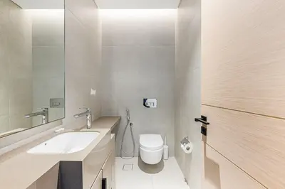 a bathroom with a white toilet and a sink at Manzil - 2BR Apartment in The Address JBR with Private Beach Access & Dubai Eye View in Dubai