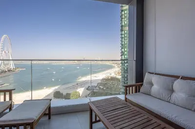a living room with a couch and a view of the beach at Manzil - 2BR Apartment in The Address JBR with Private Beach Access & Dubai Eye View in Dubai