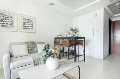 a living room with a couch and a table at Frank Porter - Lake View Tower in Dubai