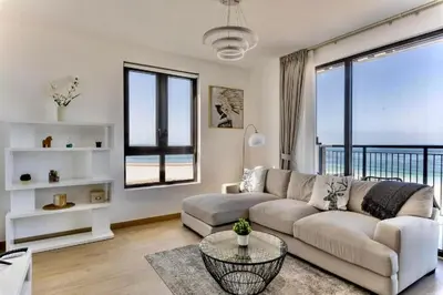 a living room with a couch and a table at Ocean Majestic Full Sea View at Le Pont in Dubai