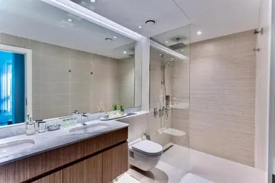 a bathroom with a toilet and a sink and a shower at Ocean Majestic Full Sea View at Le Pont in Dubai