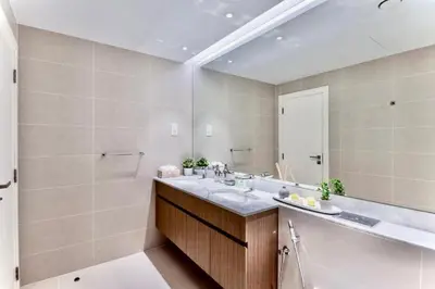 a bathroom with a sink and a large mirror at Ocean Majestic Full Sea View at Le Pont in Dubai