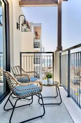 a balcony with two chairs and a table at Ocean Majestic Full Sea View at Le Pont in Dubai