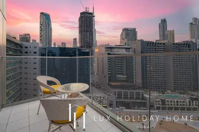 a balcony with a table and chairs and a city skyline at The Majestine Studio in Dubai