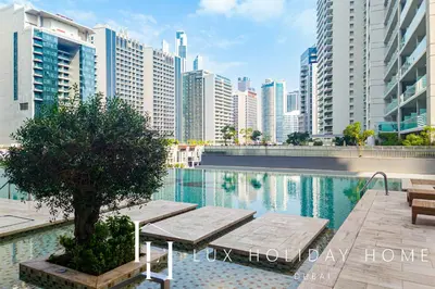 a pool with benches and buildings in a city at The Majestine Studio in Dubai