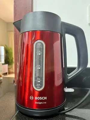 a red tea kettle sitting on a counter at Diamond Marina inn, Offers Spacious Apartment 5 min Walk To JBR Beach And METRO in Dubai