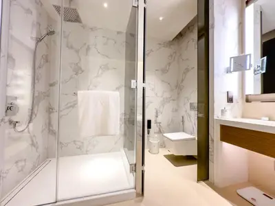 a bathroom with a shower and a toilet and a sink at The Address Residences Dubai Opera, Full Burj Khalifa View, Luxurious 2BR in Dubai