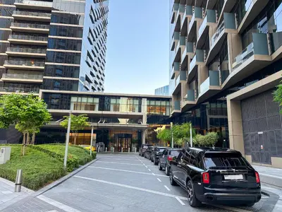 a parking lot with cars parked in front of a building at The Address Residences Dubai Opera, Full Burj Khalifa View, Luxurious 2BR in Dubai