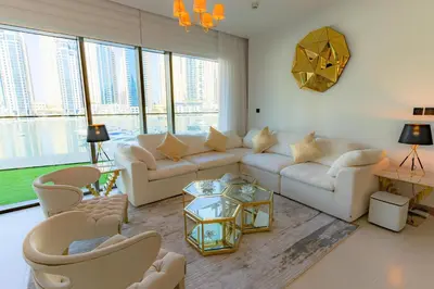 a living room with white furniture and large windows at Vida Dubai Marina & Yacht Club, Hotel and Residences, Luxurious 2BR in Dubai