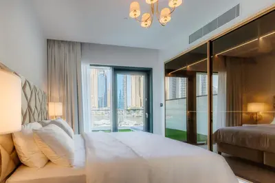 a bedroom with a bed and a large window at Vida Dubai Marina & Yacht Club, Hotel and Residences, Luxurious 2BR in Dubai