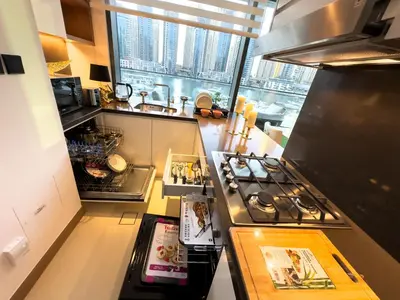 a kitchen with a stove and a large window at Vida Dubai Marina & Yacht Club, Hotel and Residences, Luxurious 2BR in Dubai