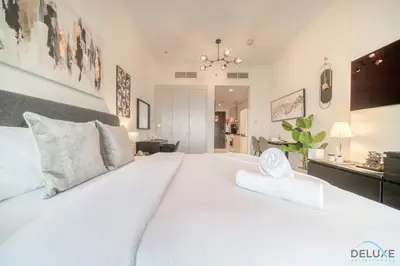 a large white bedroom with a large white bed at Appealing Studio at Carson C DAMAC Hills Dubailand by Deluxe Holiday Homes in Dubai