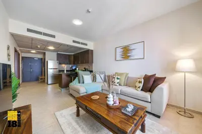 a living room with a couch and a table at Lux Sea view 1BR in Dubai Marina in Dubai