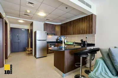 a kitchen with a refrigerator and a counter top at Lux Sea view 1BR in Dubai Marina in Dubai