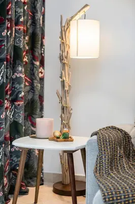 a living room with a table and a lamp at Luxury 1BR Apartment with Burj Khalifa View at Sterling in Dubai
