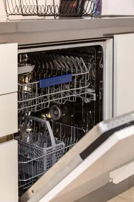 a dishwasher with dishes inside of it at Luxury 1BR Apartment with Burj Khalifa View at Sterling in Dubai