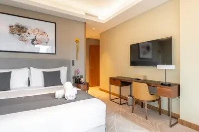 a hotel room with a bed and a desk at Address Dubai Opera Residences in Dubai