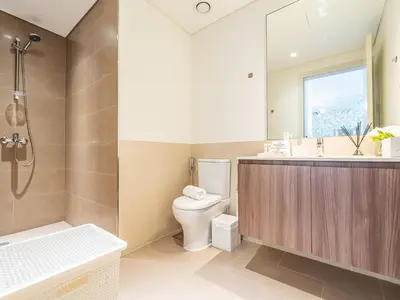 a bathroom with a toilet and a sink and a shower at Modern 1BR in Park Heights 2, Dubai Hills in Dubai