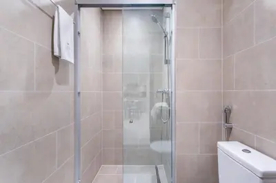 a shower with a glass door in a bathroom at STAY BY LATINEM Luxury 1BR Holiday Home CVR B1701 near Burj Khalifa in Dubai