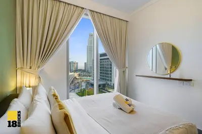 a bedroom with a large window with a view of a city at Brand New 2BR in Creek Harbour in Dubai