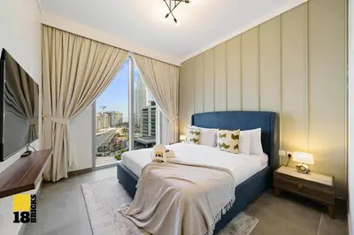 a bedroom with a large bed and a large window at Brand New 2BR in Creek Harbour in Dubai