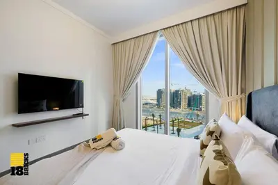a hotel room with a bed and a large window at Brand New 2BR in Creek Harbour in Dubai