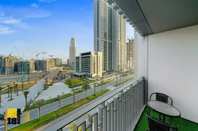a balcony with a bench and a view of a city at Brand New 2BR in Creek Harbour in Dubai