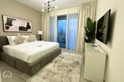 a bedroom with a large bed and a large window at Oraya - Suburban Serenity at Spacious 4BR Villa in Maple 2 in Dubai