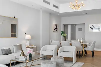 a living room with white furniture and a chandelier at Luxury 4BR Townhouse Palm Jumeirah in Dubai