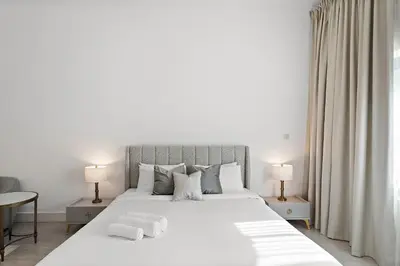 a bedroom with a large white bed with towels on it at Luxury 4BR Townhouse Palm Jumeirah in Dubai