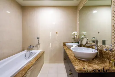 a bathroom with a tub and a sink and a tubermott at Bespoke Holiday Homes - Palm Jumeirah -2 Bedroom Sea View with Beach Access, Balqis in Dubai