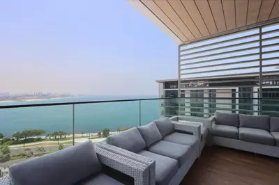 a balcony with couches and a view of the ocean at Livbnb - Bluewaters 3BR plus Maid's, with Sea Views in Dubai