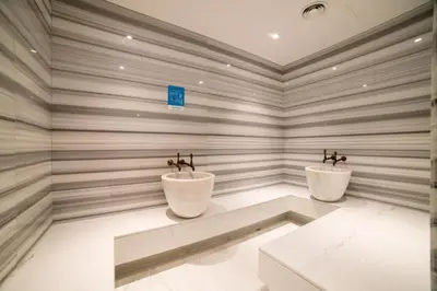 two toilets in a room with striped walls at Damac Maison Prive DVR Vacation Homes in Dubai