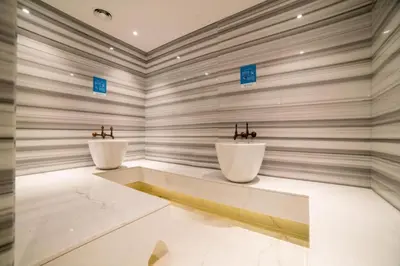a bathroom with two white sinks in a room at Damac Maison Prive DVR Vacation Homes in Dubai