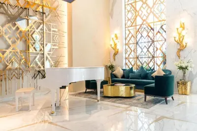 a living room with a white piano and a couch at Damac Maison Prive DVR Vacation Homes in Dubai