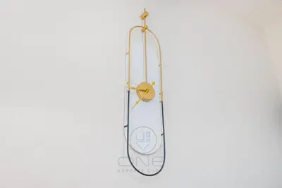 a clock is hanging on a wall with at Burj View Apartment at Vera, Business Bay in Dubai
