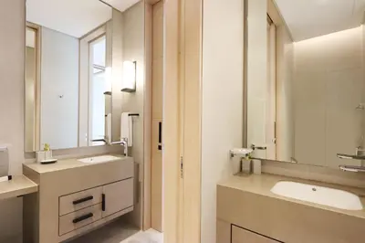 a bathroom with two sinks and a mirror at Livbnb Premium 3BR at Address JBR Posh Interiors with Sea and Ain Views in Dubai