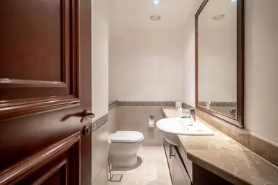 a bathroom with a toilet and a sink and a mirror at Stylish Urban Retreat 1BR Gem Fairmont Residence - 90AB2 in Dubai