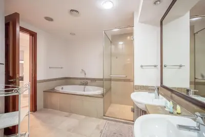 a bathroom with a tub and a sink at Stylish Urban Retreat 1BR Gem Fairmont Residence - 90AB2 in Dubai