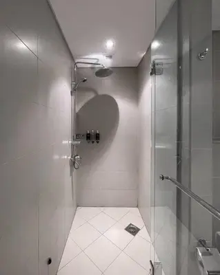 a bathroom with a shower with a glass door at Authentic 2 bdr in Anantara Resort Palm Jumeirah in Dubai
