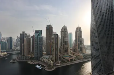 a group of tall buildings in a large city at Livbnb Elegant 3BR in Marina Gate Panoramic Marina Views with Private Balcony in Dubai