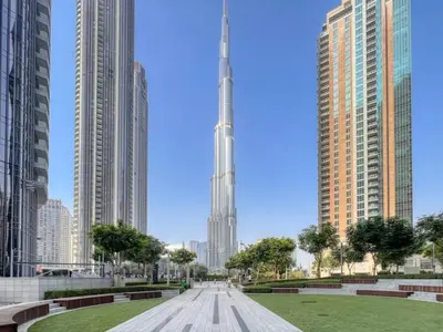 a view of the burj khalifa from a park in a city at Spacious and Overlooking Burj & Fountains in Dubai
