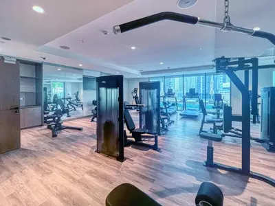 a gym with treadmills and exercise equipment in a building at Spacious and Overlooking Burj & Fountains in Dubai