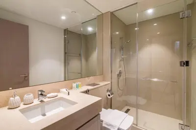 a bathroom with a sink and a shower at Spacious and Overlooking Burj & Fountains in Dubai