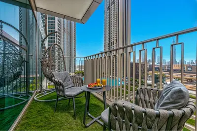 two chairs and a table on a balcony with a view at Dubai Mall Connection - Burj Views - Turf Balcony in Dubai