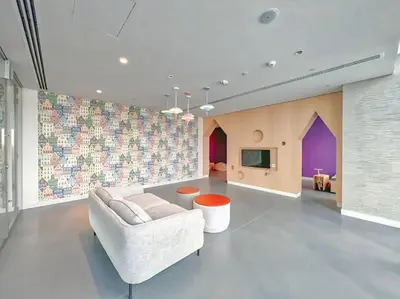 a living room with a white couch and a tv at Dubai Mall Connection - Burj Views - Turf Balcony in Dubai