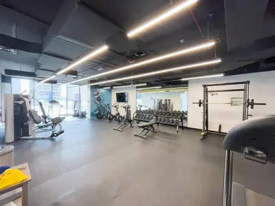 a gym with several treadmills and machines in a room at NEW Listing - Czechin - JBR Beach a Few Steps Away in Dubai