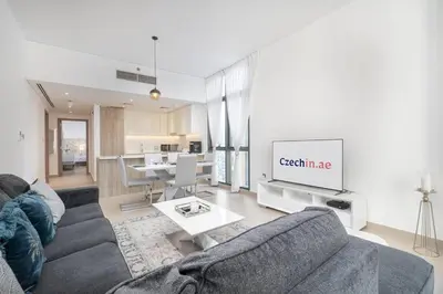 a living room with a couch and a tv at NEW Listing - Czechin - JBR Beach a Few Steps Away in Dubai