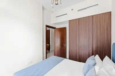 a bedroom with a bed and a wooden headboard at Aliving Exclusive 1BR Reva Residence Business Bay-218 in Dubai